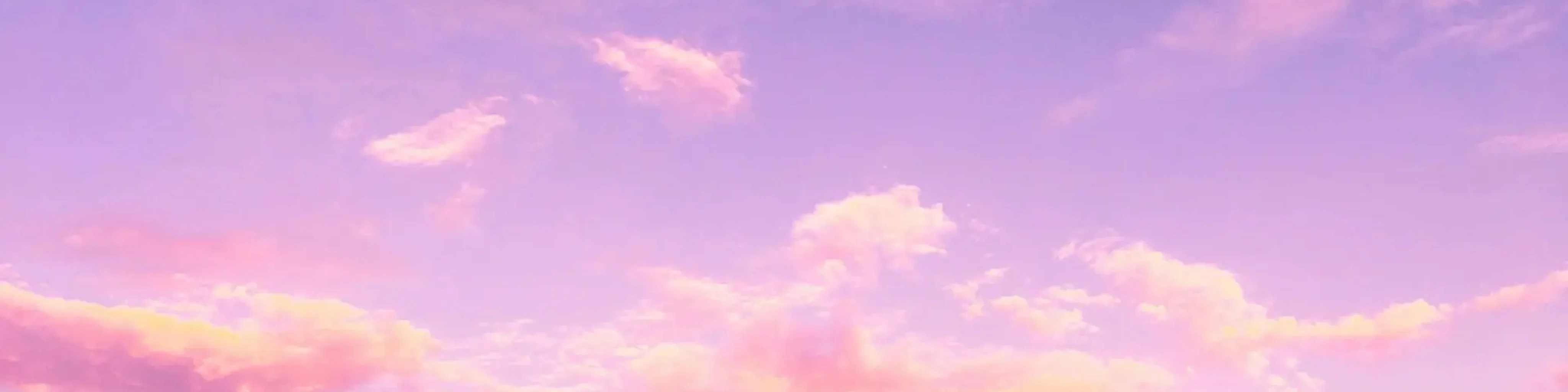 A dreamy pink and purple cloud-filled sky at sunset, creating a serene and tranquil atmosphere.